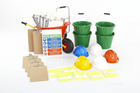 Construction-themed play set with safety hats, buckets, and tools on a white background