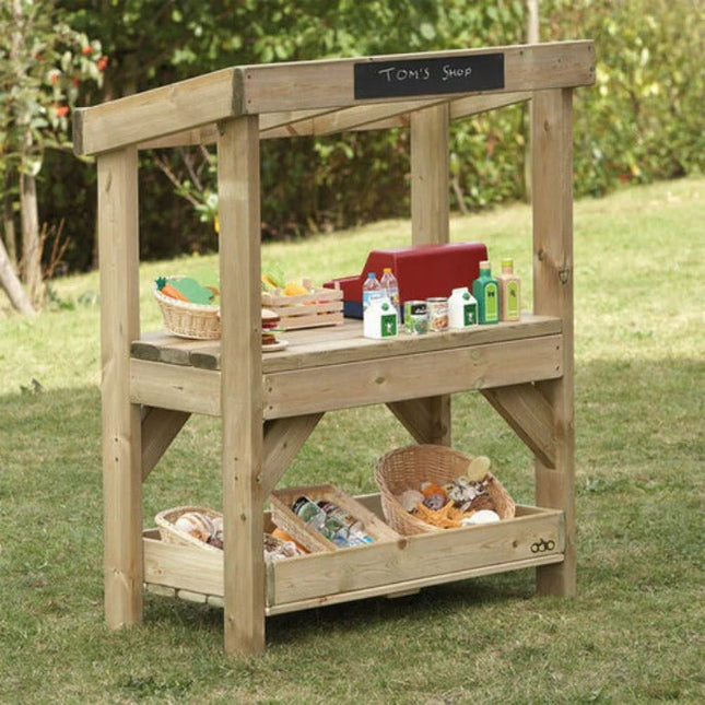 Wooden toy shop set up outdoors with various toys and items on a grassy background.