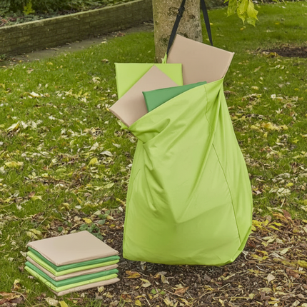Green and beige outdoor cushions on a grassy area