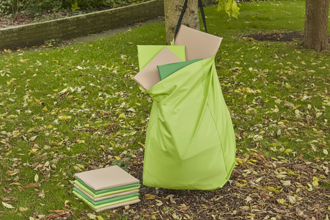Green and beige outdoor cushions on a grassy area