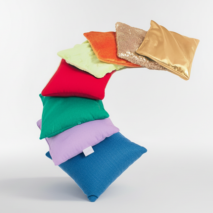 Colorful fabric squares stacked on a white background