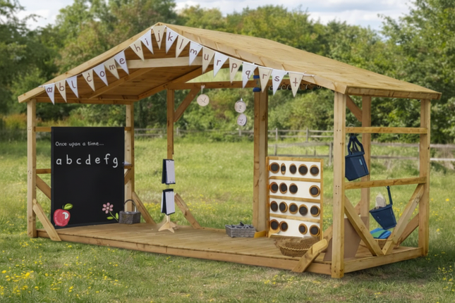 Wooden playhouse with educational items on a grassy field